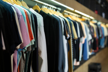 Assorted casual clothes on shelves and hangers at shopping mall