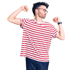 Young hispanic man wearing casual clothes showing arms muscles smiling proud. fitness concept.