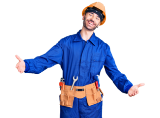 Young hispanic man wearing worker uniform looking at the camera smiling with open arms for hug. cheerful expression embracing happiness.