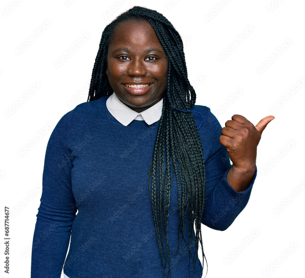 Sticker Young black woman with braids wearing casual clothes smiling with happy face looking and pointing to the side with thumb up.