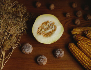Still life, yellow melon, walnuts, gingerbread, dried dill on the table, home atmosphere.