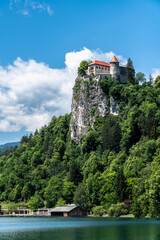 Beautiful view of Lake Bled and Bled Castle above the cliff on a sunny summer day with blue sky cloud, Bled, Slovenia - 687715605