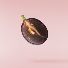 Fresh organic Blue Grape falling in the air isolated