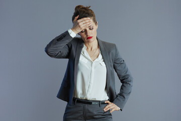stressed modern woman worker isolated on grey background