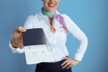 Closeup on happy elegant stewardess woman on blue