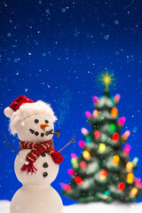 A happy snowman wearing Santa hat with Christmas tree as it is snowing