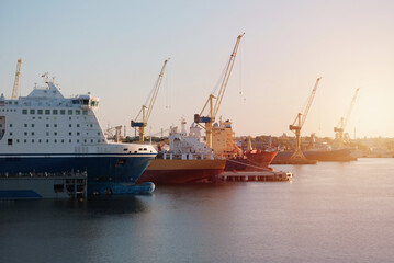 Fototapeta premium Different Type Vessels During The Dry-Docking Period and Essential Engine Repairs. Hull Survey Of The Ships. Ships In The Shipyard. Shipbuilding.