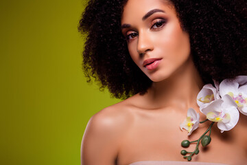 Photo of gorgeous stunning lady with orchid flower on chest beauty product for soft skin concept over green background