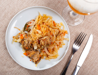 Stewed white cabbage with pork ribs, carrots and bay leaf