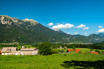 Beautiful panorama idyllic view of Veliki Stol (Hochstuhl) massif at border between Slovenia and Austria with pasture in foreground on a sunny summer day from Bled with blue sky cloud.