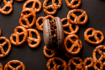 Close-up of one brown macaroon with chocolate cream