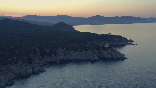 Aerial drone view of Capo Ferrato cape lighthouse on the coast of Sardinia, Italy at sunset
