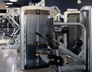 Triceps press machine standing in middle of gym
