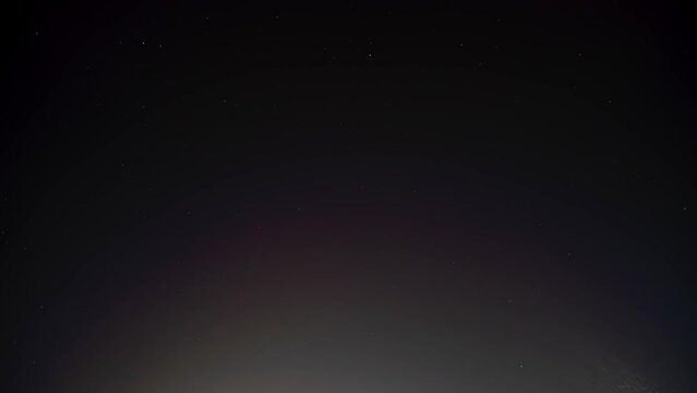 Night sky timelapse over Toronto, Ontario, Canada. Moving rotation of stars, background time lapse.  Black space and sky at night in light polluted area downtown.