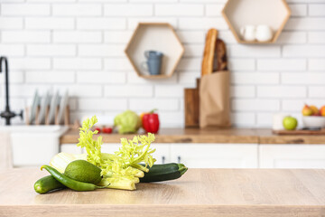 Fresh vegetables on wooden table in modern kitchen