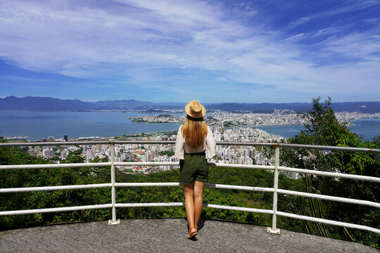 Traveling in Brazil. Panoramic view of tourist woman with hat in Florianopolis city, Santa Catarina, Brazil.