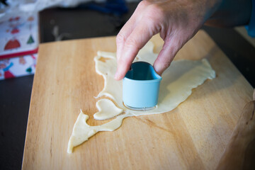 Woman hand making heart shaped cookies