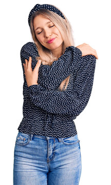 Young beautiful blonde woman wearing casual clothes hugging oneself happy and positive, smiling confident. self love and self care