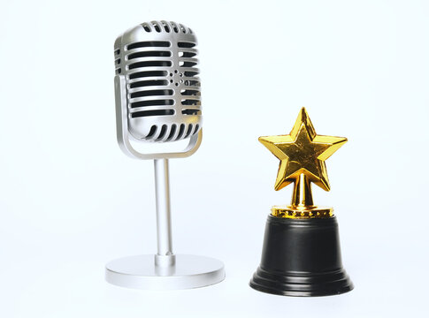 A picture of microphone and star trophy on  white background.