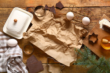 Different tools and ingredients for Christmas gingerbread cookies on brown wooden background