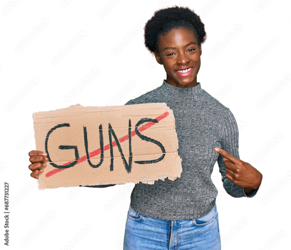 Poster Young african american girl holding no guns warning banner smiling happy pointing with hand and finger