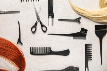 Different hair with set of hairdresser's tools on grey background