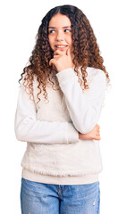 Beautiful kid girl with curly hair wearing casual clothes with hand on chin thinking about question, pensive expression. smiling with thoughtful face. doubt concept.