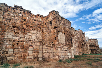 Fototapeta na wymiar Fragment of stone, medieval defensive walls in the city of Chania on the island of Crete