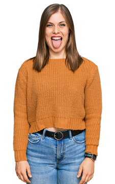 Beautiful caucasian woman wearing casual clothes sticking tongue out happy with funny expression. emotion concept.