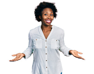 African american woman with afro hair wearing casual white t shirt clueless and confused expression...