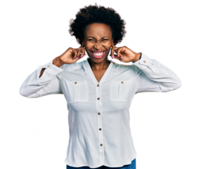 African american woman with afro hair wearing casual white t shirt covering ears with fingers with annoyed expression for the noise of loud music. deaf concept.