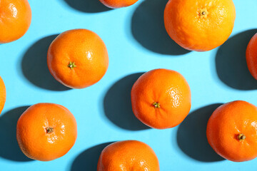 Many sweet mandarins on blue background