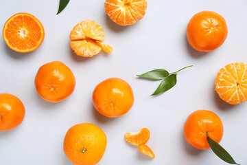 Sweet mandarins and leaves on white background