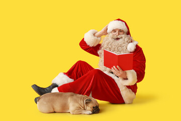 Shocked Santa Claus with cute French bulldog reading book on yellow background