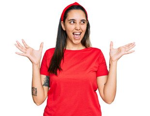 Young hispanic woman wearing casual clothes crazy and mad shouting and yelling with aggressive...