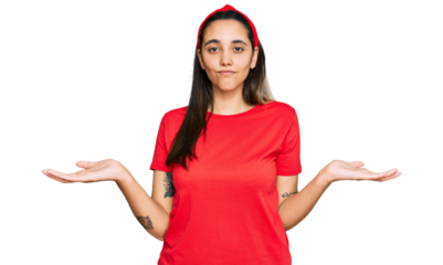 Young hispanic woman wearing casual clothes clueless and confused expression with arms and hands raised. doubt concept.