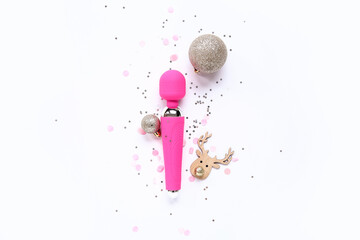 Composition with pink vibrator and Christmas decorations on white background