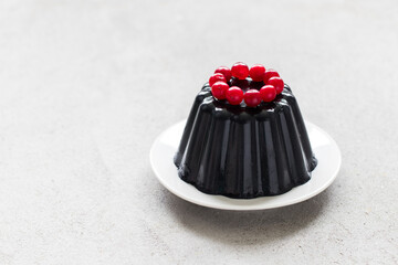 Vegan Black Matcha Cream pudding, Panna Cotta decorated with cranberries. Copy space