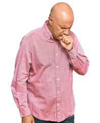 Middle age bald man wearing casual clothes feeling unwell and coughing as symptom for cold or bronchitis. health care concept.