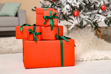 Beautiful decorated Christmas tree and gifts on floor