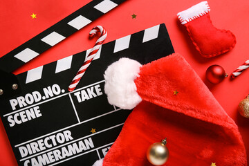 Movie clapper with Christmas decor on red background