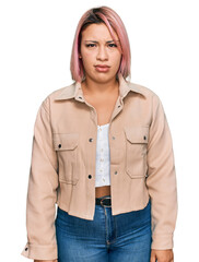 Hispanic woman with pink hair wearing casual clothes skeptic and nervous, frowning upset because of problem. negative person.