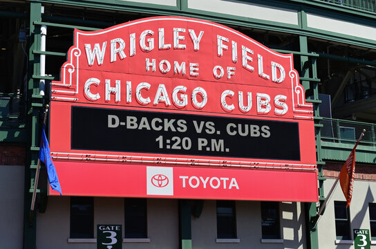 The iconic marquee above the main entry gate to Wrigley Field, home of the Chicago Cubs, on game day afternoon. The neighborhood ballpark is a true landmark of national proportions. 