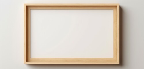 A wooden picture frame on a beige wall is photographed by a camera, presenting a blank canvas for creative expression.