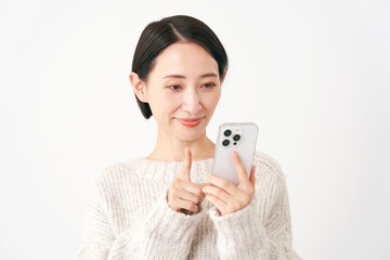 Fototapeta premium スマホを使うミドルエイジの女性 白背景