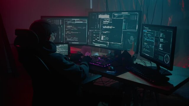 Hacker with pc committing crime during night at basement