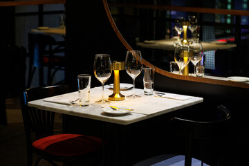 A cozy and elegant table setting for a romantic dinner in a dimly lit restaurant