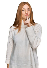 Young irish woman wearing casual winter sweater asking to be quiet with finger on lips. silence and...