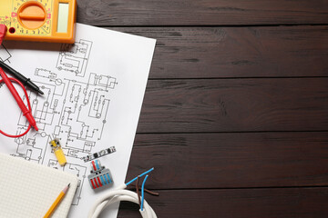 Wiring diagram, office stationery, wires and digital multimeter on wooden table, top view. Space for text
