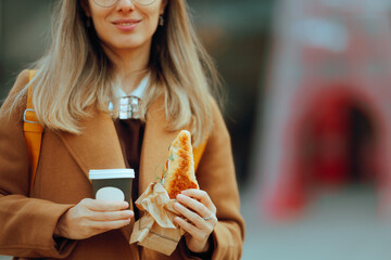 Woman Holding her Coffee and Sandwich to Go. Person taking a lunch break eating a snack having a...